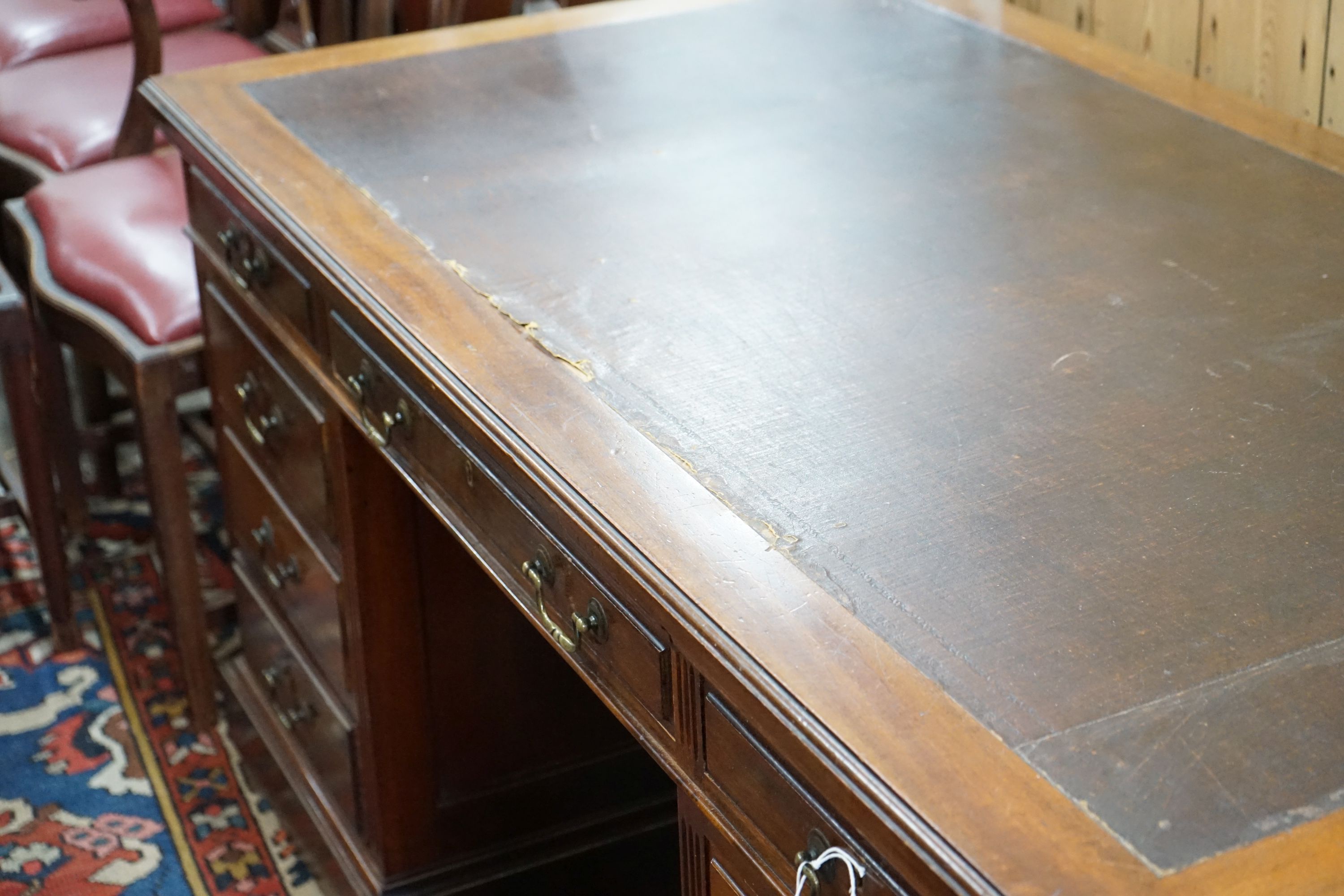 A reproduction Georgian style mahogany twin pedestal desk, fitted nine short drawers, on plinth base, width 152cm, depth 83cm, height 76cm
